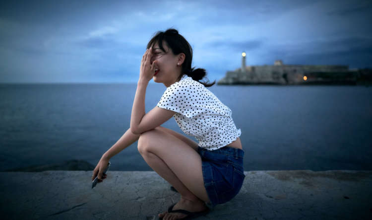 Asian Woman Sitting By Water